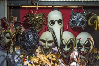 Venetian carnival masks in a shop window, Venice, Veneto, Italy