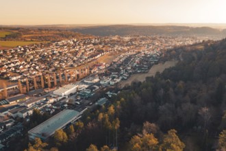 Panoramic view of a town adjacent to dense forest under evening sun, Aidlingen, Böblingen District,