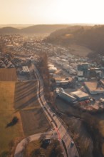 Urban and industrial zones alongside fields and hills in sunset light, Aidlingen, Böblingen