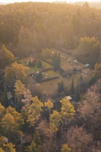 Cabins nestled in a forest displaying vivid autumn colors at Dusk, Aidlingen, Böblingen District,