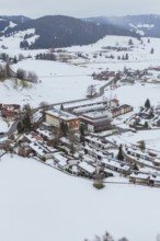 A small village in a snowy landscape with clearly visible roads and buildings, specialist clinic