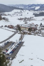 Snow scenario in a small village with parking lots and roads taken from the air, specialist clinic