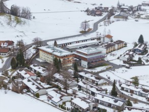 Snowy village with views of roofs and roads from above, specialist clinic for psychosomatics and