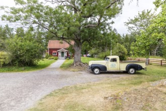 Typical Sweden, Swedish red country house and old car, Virum Älkpark near Vimmerby, Kalmar län,