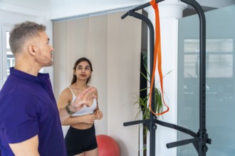 Physiotherapist explaining exercise instructions to a female patient. Providing guidance and