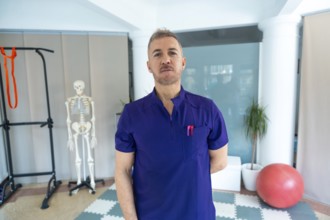 Physiotherapist standing confidently in a modern recovery clinic, offering sports osteopathy and
