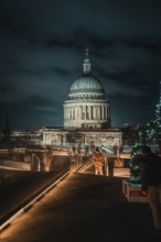 Atmospheric view of illuminated St. Paul's Cathedral from a roof terrace with Christmas