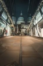 View of illuminated St. Paul's Cathedral through modern glass facades at night, London, Great