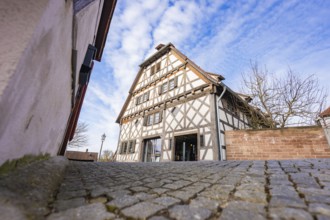 Timbered house on cobblestone road, traditional style under blue sky, Ötisheim, Enzkreis, Germany