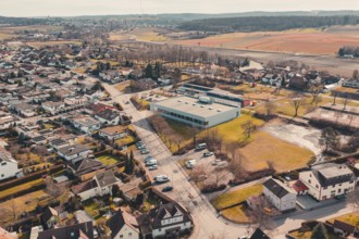 Bird's eye view of a village with buildings and natural fields in the background, Ötisheim,