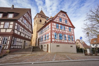 Half-timbered houses and church tower on a paved road in a historic setting, Ötisheim, Enzkreis,