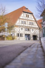 Historic half-timbered house on a quiet street in sunny spring weather, Ötisheim, Enzkreis, Germany