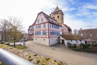 Village view with half-timbered houses and church tower under blue sky, Ötisheim, Enzkreis, Germany
