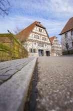 Street scene with traditional half-timbered house and tiled roof under sky, Ötisheim, Enzkreis,