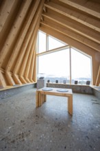 Modern interior with wooden elements and large window showing nature, Sinnraum, Oberreute, Allgäu,