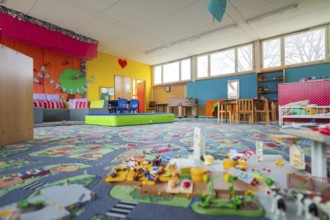 Friendly play area with colorful walls and toys, suitable for lively play, homework supervision,
