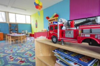 Child-friendly room with toy fire department and colorful walls, suitable for imaginative fun,