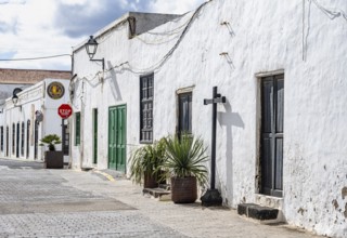 Typical white houses with colored doors and windows in an alley, Teguise, Lanzarote, Canary