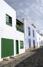 Typical white houses with colored doors and windows in an alley, Teguise, Lanzarote, Canary
