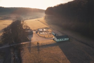 Early morning atmosphere with rays of light on sewage treatment plant in a rural area, Gechingen,