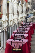 Tables set on the canal of a restaurant, Venice, Veneto, Italy