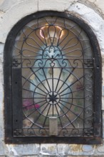 Figure of Mary in a niche on a residential building façade, Venice, Veneto, Italy