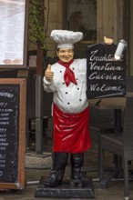 Chef as an advertising character with an offer in front of a restaurant, Venice, Veneto, Italy
