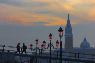 Silhouette of lanterns and San Giorgio Maggiore church at sunset, Venice, Veneto, Italy