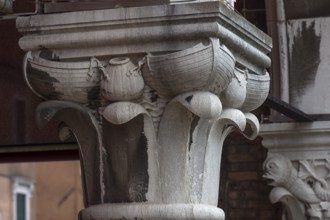 Captain design with fishing boats on the arcades of the historic market in Rialto, Venice, Veneto,