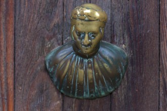 Male bronze figure as doorknob, Venice, Veneto, Italy