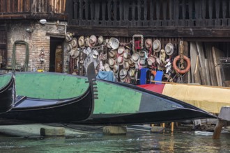 Gondolier straw hats on a wooden wall of a shipyard, Venice, Veneto, Italy