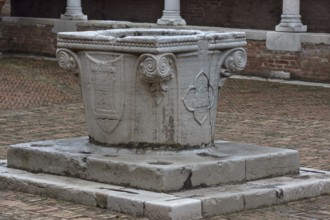 Historic fountain in the courtyard of the Madonna dell'Oro parish church, Venice, Veneto, Italy