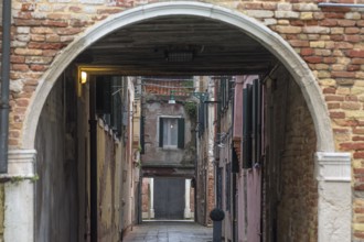 View of an alley in the old town through an archway, Venice, Veneto, Italy