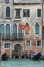 Waving flag of the Republic of Venice on a residential building, Venice, Venice, Italy
