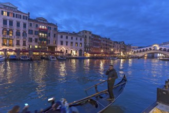 Grand Canal with Rialto Bridge in the evening, gondola in front, Venice, Veneto, Italy