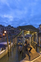 Gondolier waiting for tourists, Venice, Veneto, Italy