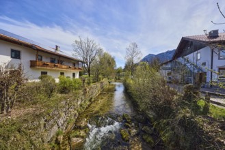 Rote Traun river, fortified bank, riverbed, quarry stone wall, rapids with stones, bushes with