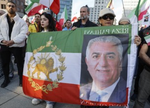 Iranians demonstrate with a poster of Prince Reza Pahlavi on the day of the US and Israeli attack
