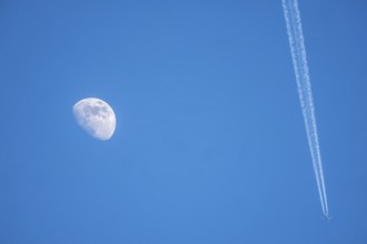 The moon, crescent, increasing, airplane, with contrails
