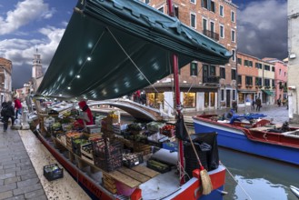 Selling fruit and vegetables from a ship, Venice, Veneto, Italy