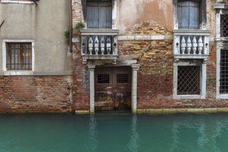 Detail of a house façade in the old town during high tide, Venice, Veneto, Italy