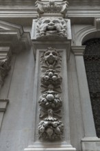 Fruit and animal sculptures on a pillar of a church, Venice, Veneto, Italy