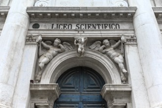 Entrance portal with angel sculptures from the University of Science, Venice, Veneto, Italy