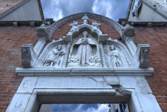 Entrance gate with the mantle Madonna flanked by saints, Venice, Veneto, Italy