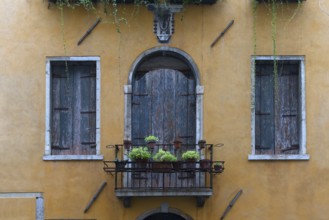 Closed windows and balcony of an old residential building in the old town, Venice, Veneto, Italy