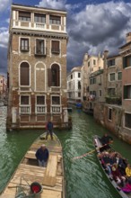 Historic Palazzo Tetta, on the canal, gondola with tourists and workboat, Venice, Veneto, Italy