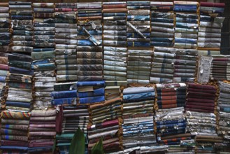 Stacked books after flood damage in a bookstore, Venice, Veneto, Italy