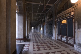 Empty arcades of the Old Procuration, 16th century, St. Mark's Square early in the morning Venice,