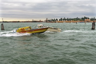 Venetian ambulance in action, San Michele cemetery in the back, Venice, Veneto, Italy