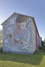 Mural by CASE MacAclaim and Millo 2023, street art, boy with apple tree in hands, protecting,